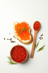 Sandwich, wooden bowl and spoon with caviar on white background, top view