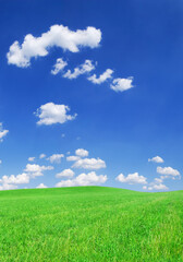 Fototapeta na wymiar Idyllic view, green hills and blue sky with white clouds
