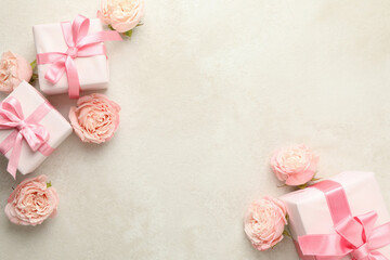 Gift boxes and roses on white textured background, space for text