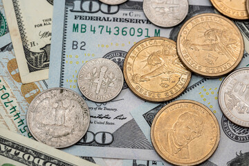 US coins on dollar bills background