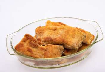 Breaded fish fillets in a glass, heat-resistant dish
