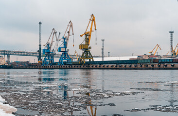  View on the sea port with gantry cranes. Cranes in cargo port of St. Petersburg in winter time
