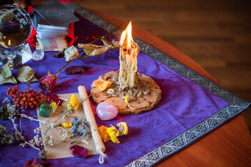 Candle burns a herb on the altar, magic among candles, clean negative energy, wicca  concept