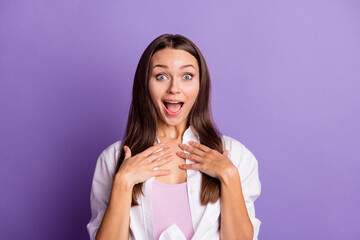 Photo of amazed shocked girl palms chest open mouth wear white shirt isolated purple color background