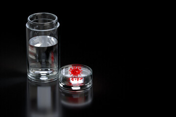 Coronavirus COVID-19 in jar of water liquid with syringe