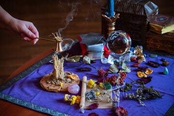 Candle burns a herb on the altar, magic among candles, clean negative energy, wicca  concept