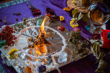 Candle burns a herb on the altar, magic among candles, clean negative energy, wicca  concept