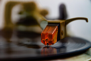Close up of a turntable acoustic pickup with needle on a vinyl record, selective focus © Robert Knapp