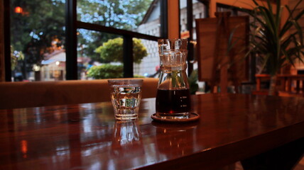 Selective focus image, Alternative coffee and a glass of water stand on a wooden table. 