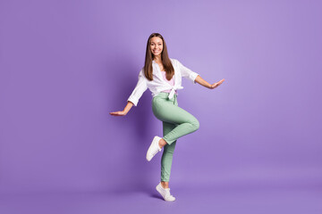 Fototapeta na wymiar Photo portrait full body view of cute girl standing on one leg isolated on vivid purple colored background