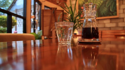 Selective focus image, Alternative coffee and a glass of water stand on a wooden table. 