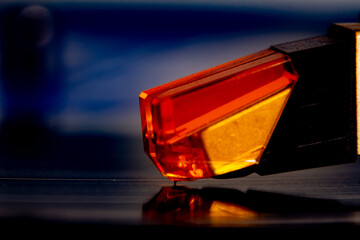 Close up of a turntable acoustic pickup with needle on a vinyl record, selective focus © Robert Knapp