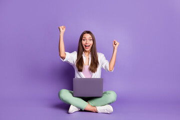 Photo portrait full body view of girl with laptop celebrating sitting in lotus pose isolated on...