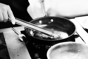 Chef cooking in a kitchen, chef at work, Black and White.