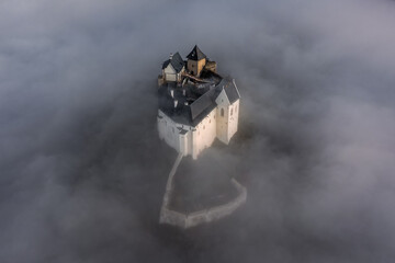 Fuzer, Hungary - Aerial view of the beautiful Castle of Fuzer standing out of the fog on an autumn morning. This castle has been located in the Zemplen Mountains