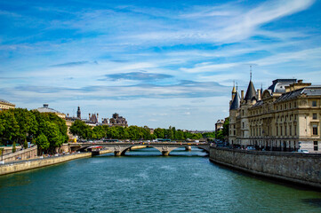 Paris, France - July 18, 2019: Scenic view of River Seine with the Conciergerie and Bridge of Change (Pont au Change) in Paris, France