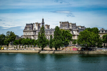Paris, France - July 18, 2019: View of HÃ´tel de Ville (French, "City Hall") from the bank of River Seine in Paris, France. The building houses the city's local administration.