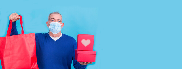 attractive man with protective mask on his face for coronavirus or covid-19 and present concept...