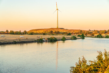 Obraz premium Evening at the River Ruhr with a wind turbine in the background, seen in Duisburg, North Rhine-Westfalia, Germany