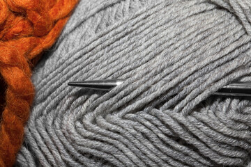 Skein of wool with knitting needles, closeup.