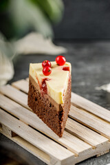 Close up of a slice of delicious cake with red currant and cheesy whipped cream. Tasty cheesecake