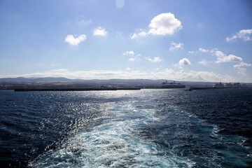 evocative image of the water trail at sunset from the stern of a ferry 
