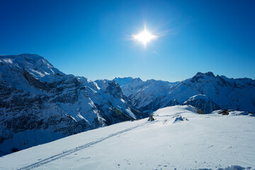 Fototapeta na wymiar Panorama of French alps mountain tops in Savoie region on sunny day at winter