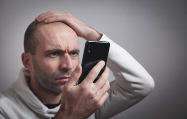 Man looking at mobile phone screen. Social Media Addiction