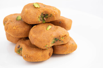 Indian Subcontinental Dessert Mathura Peda Or Pera Originating From Holy Mathura, Sacred Birthplace Of Diety Hindu God Lord Krishna Is Made Of Milk Fudge Khoya Mawa Kesar Pista Mava Malai In Desi Ghee