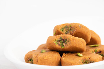 Indian Subcontinental Dessert Mathura Peda Or Pera Originating From Holy Mathura, Sacred Birthplace Of Diety Hindu God Lord Krishna Is Made Of Milk Fudge Khoya Mawa Kesar Pista Mava Malai In Desi Ghee