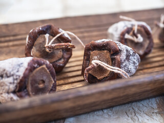 Dried persimmon on a wooden tray close-up blurred focus at close range