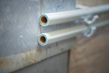 old plastic water pipes on the wall