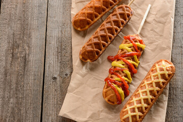 Freshly cooked corn dogs on a wooden table