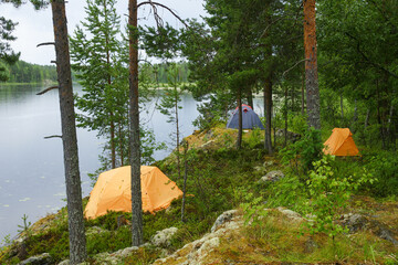 Tents on rocky shore of Unitskaya Bay of Lake Onega, Republic of Karelia, Russia