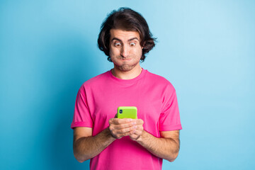 Portrait of nice focused puzzled funky guy using gadget blogging post smm blowing cheeks isolated...