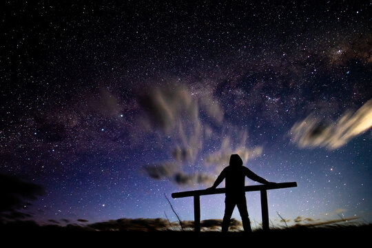 Silhouette Of A Man Stargazing In Tekapo, New Zealand