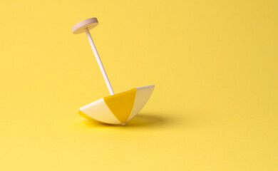 multicolored beach umbrella on yellow background