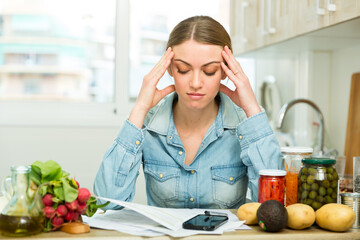 Woman counting money for paying bills at kitchen. High quality photo