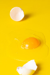 broken egg isolated on a yellow background