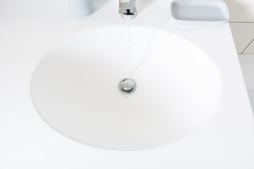 Modern bathroom detail in a luxury home, white sink and chrome tap