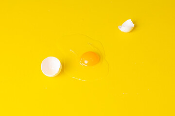 broken egg isolated on a yellow background