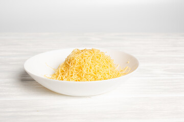 fresh grated cheese. Grater and cheese on board