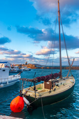 Traditional Cycladitic view with moored traditional fishing boats at the picturesque harbor of...