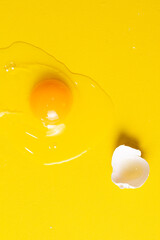 broken egg isolated on a yellow background