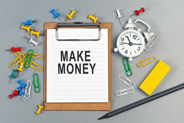 The words Make Money written on a white notebook
