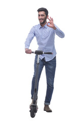 Fototapeta premium in full growth. happy young man with an electric scooter