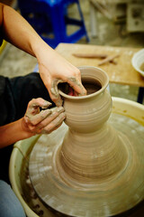 Fototapeta na wymiar working with clay on potter's wheel