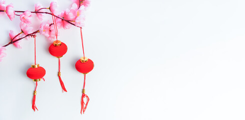 Happy Chinese new year 2021 or Lunar New Year Flat lay decoration festival Red Pendant Ornaments Knot and Pink cherry. Copy Space Concept