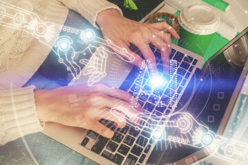 Double exposure of woman hands working on computer and data theme hologram drawing. Tech concept.