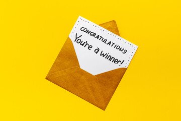 You are a winner. Golden envelope with congratulation card. Top view